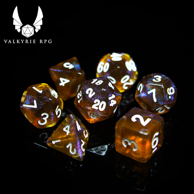 Valkyrie RPG | Online Dice Store UK | Helheim Brass Dragon - Beautiful colour shifting purple and brass toned glitters with blends of deep varying tones of amber finished with white inking. 